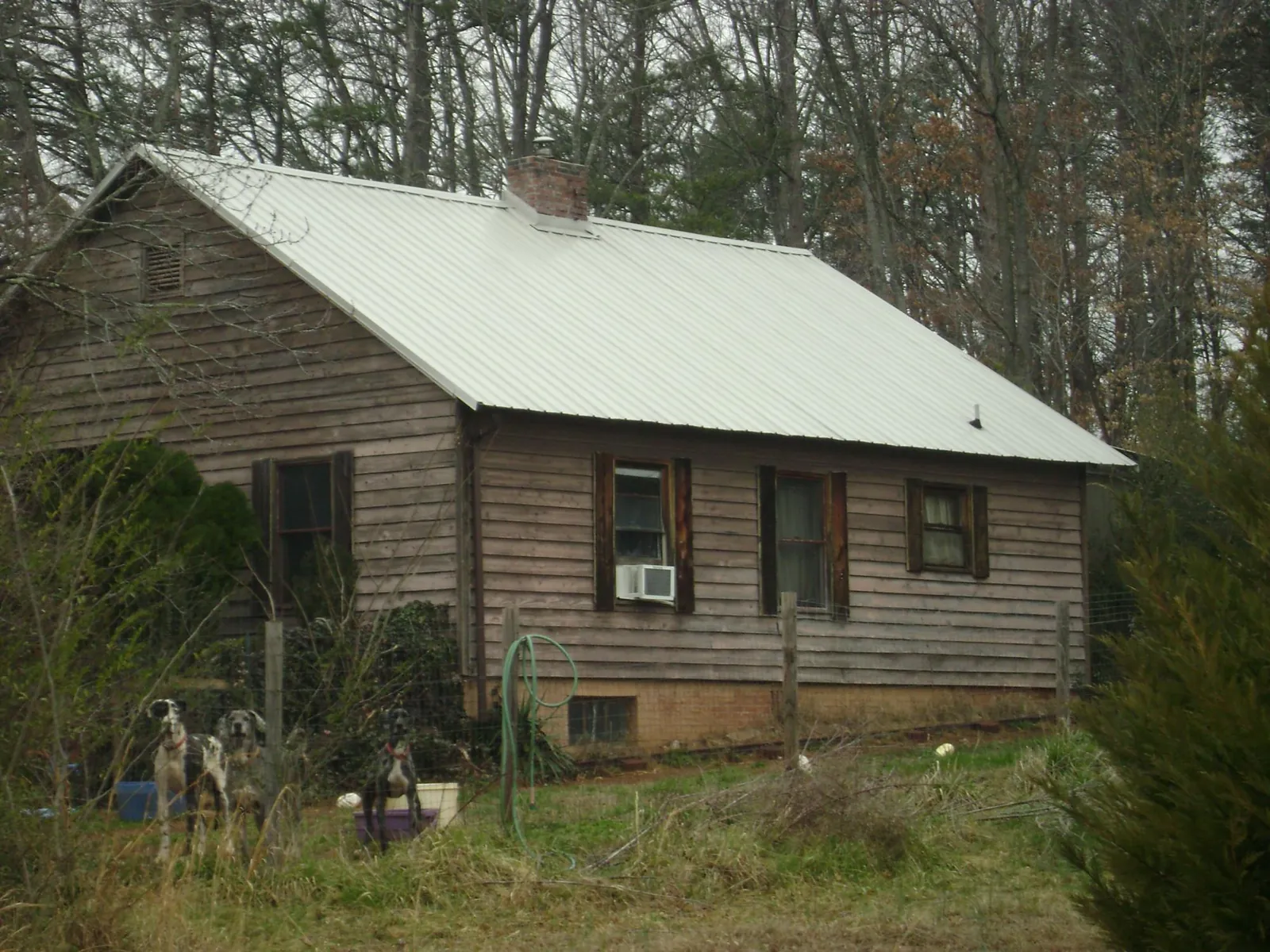 White metal roof on an old wood sided farmhouse, from a Metal Roof Installation job in Port Reading